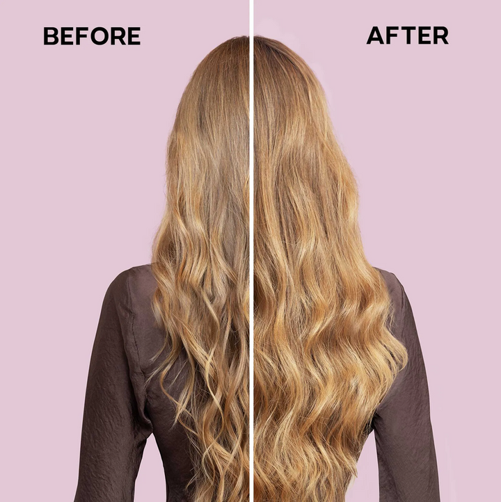 Before and after comparison of a woman's long, wavy blonde hair, shown from the back against a solid light pink background. The left side is labeled 'BEFORE' and shows slightly drier, straighter hair, while the right side is labeled 'AFTER' and shows shinier, smoother, and more voluminous waves.