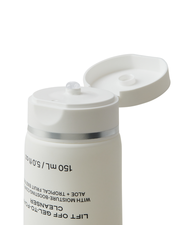 White skincare product container with a silver band on a white background