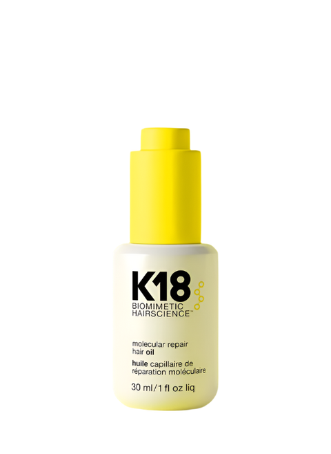 K18 repair hair oil bottle on a yellow background