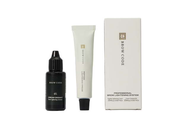 Brow Code skincare products including a bottle, tube, and box on a white background