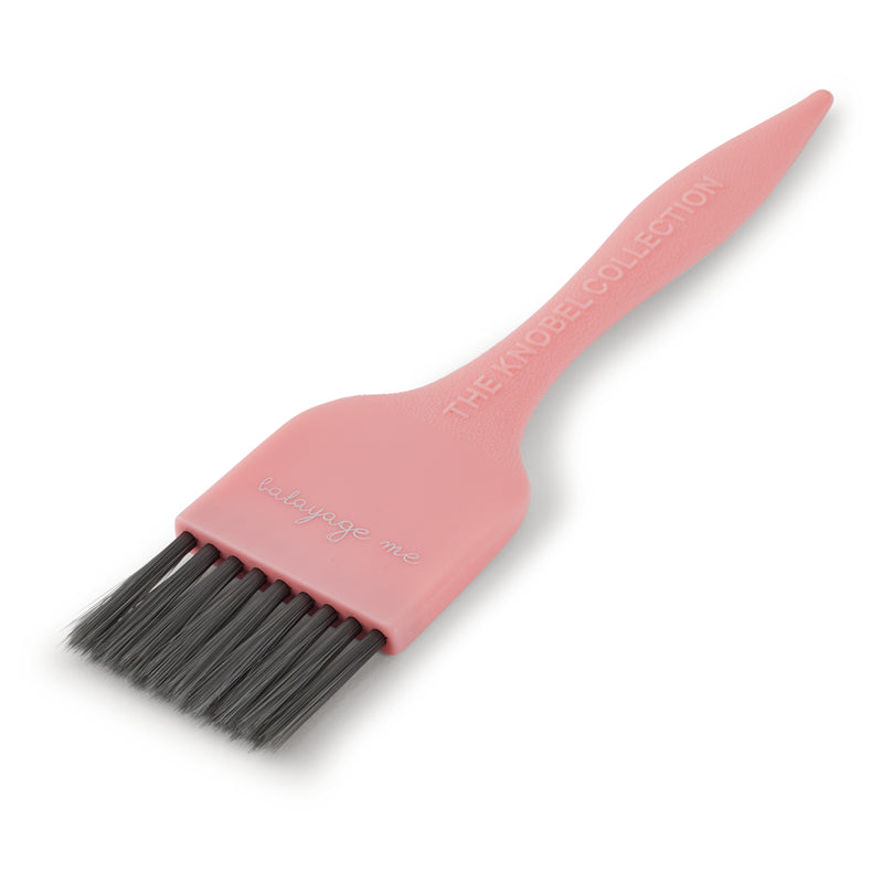 Pink tint brush with black bristles on a white background