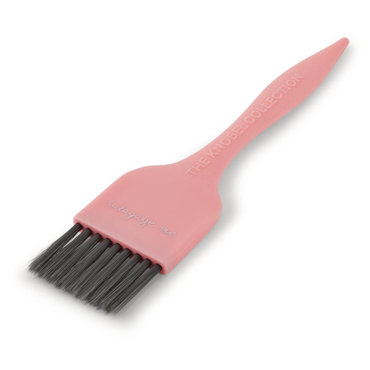Pink tint brush with black bristles on a white background