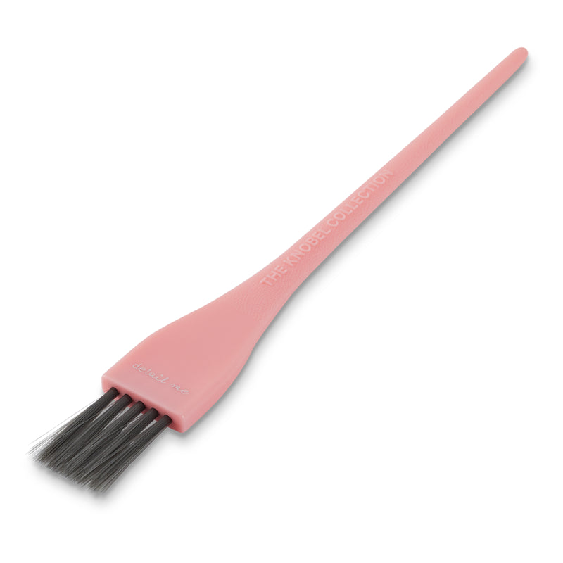 Pink tint brush with black bristles on a white background