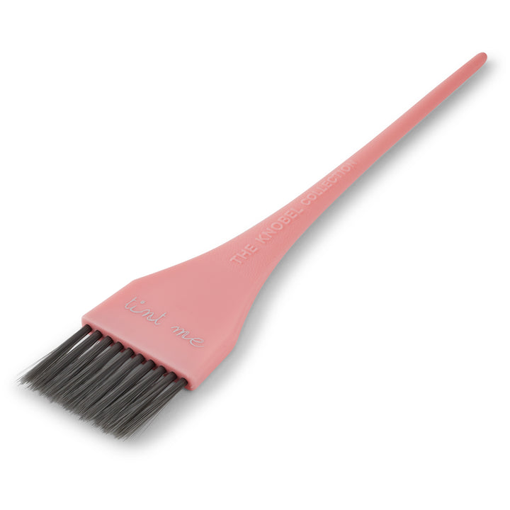 Pink tint brush
 with black bristles on a white background