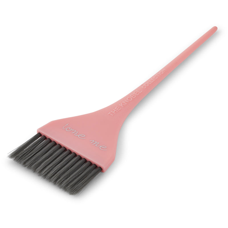 Pink tint brush with black bristles on a white background